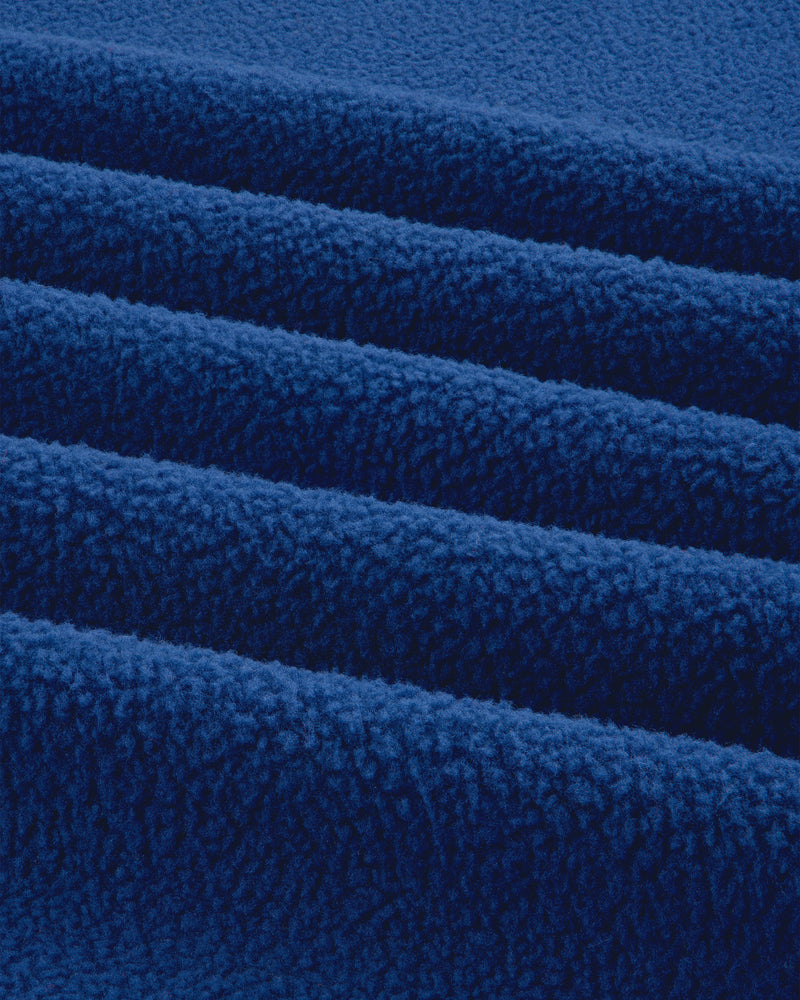 Close-up of the ALD / The North Face Packable Fleece Blanket, showing its soft, bright blue textured layers.