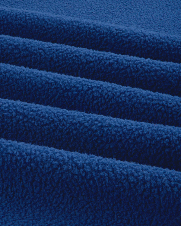 Close-up of ALD / The North Face Denali Fleece Scarf shows soft blue fabric with textured surface and parallel folds.