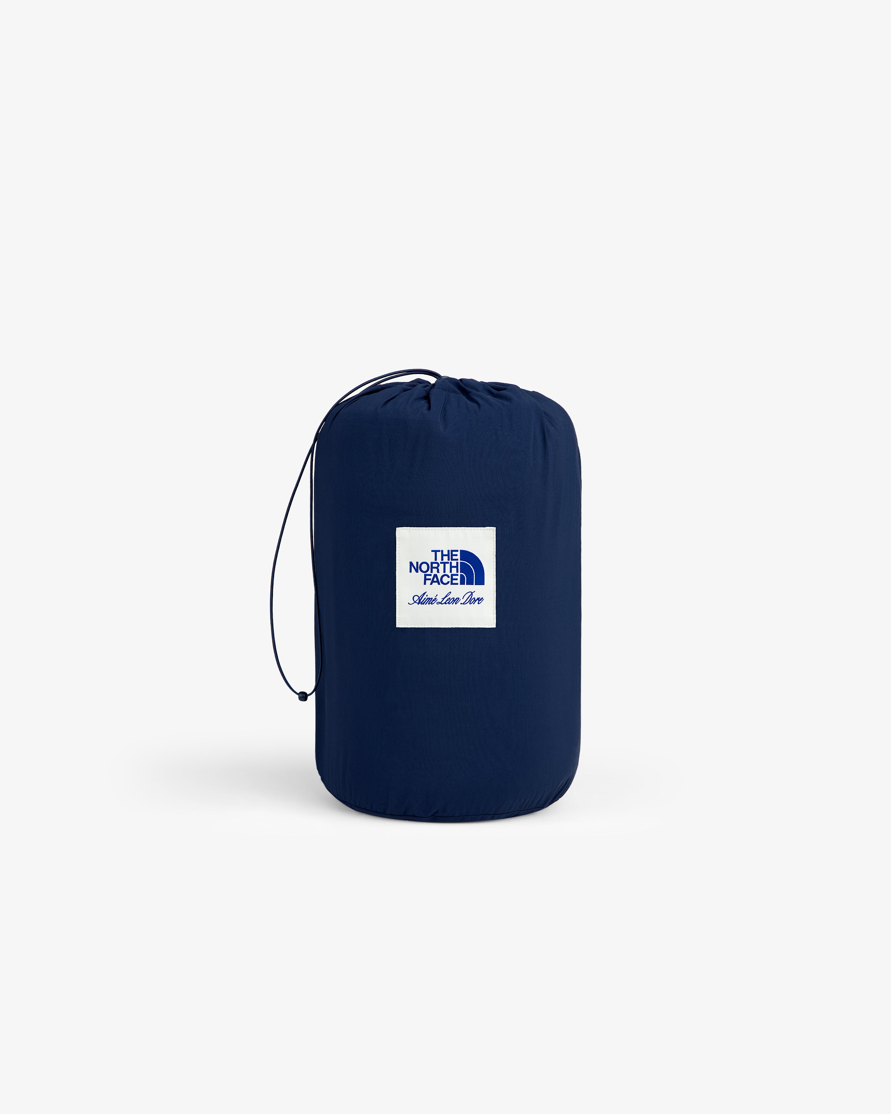 A blue ALD / The North Face Packable Fleece Blanket, drawstring sack and logo patch on a plain white background.