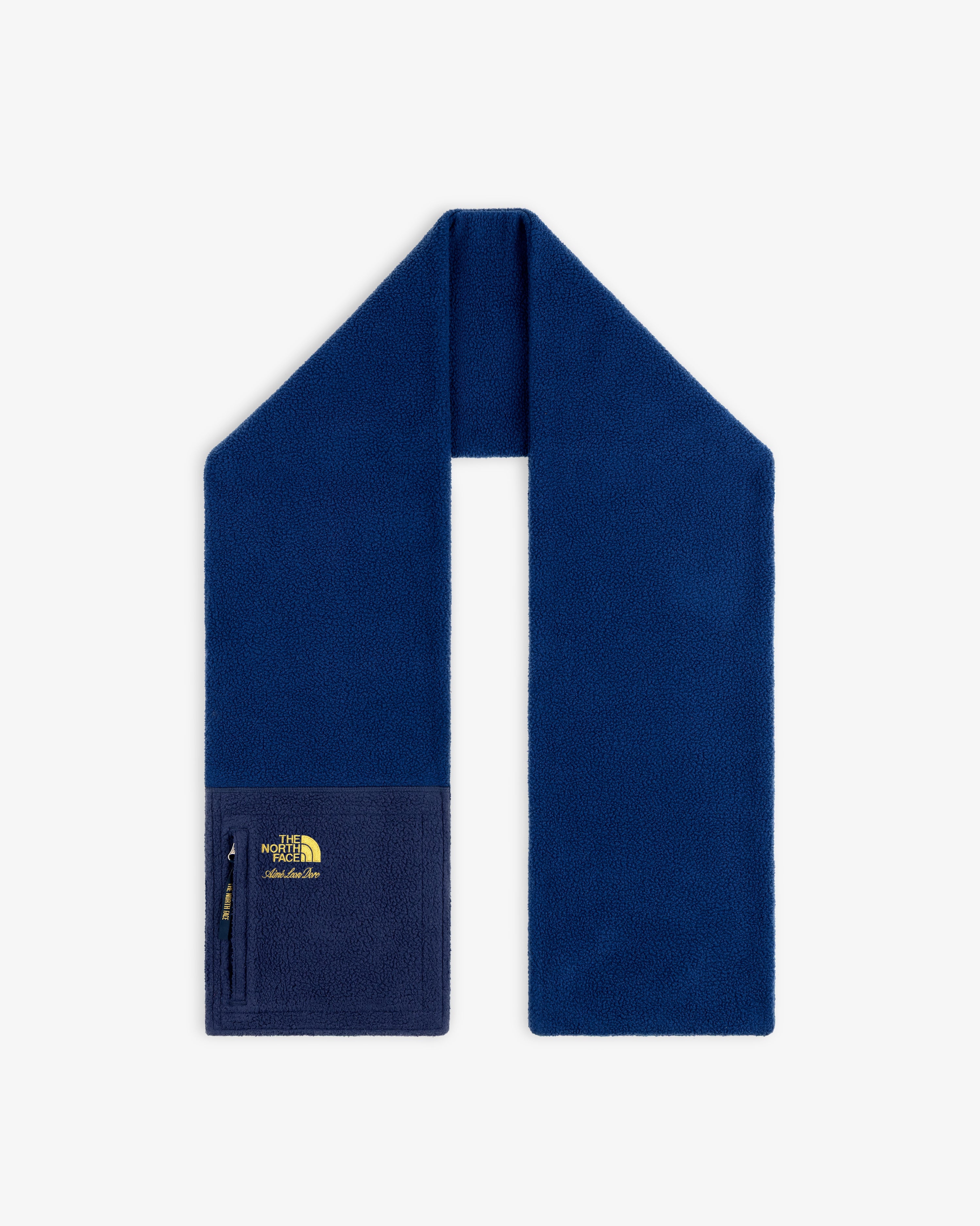 ALD / The North Face Denali fleece scarf in blue with zippered pocket and yellow logo on one end, shown on white.