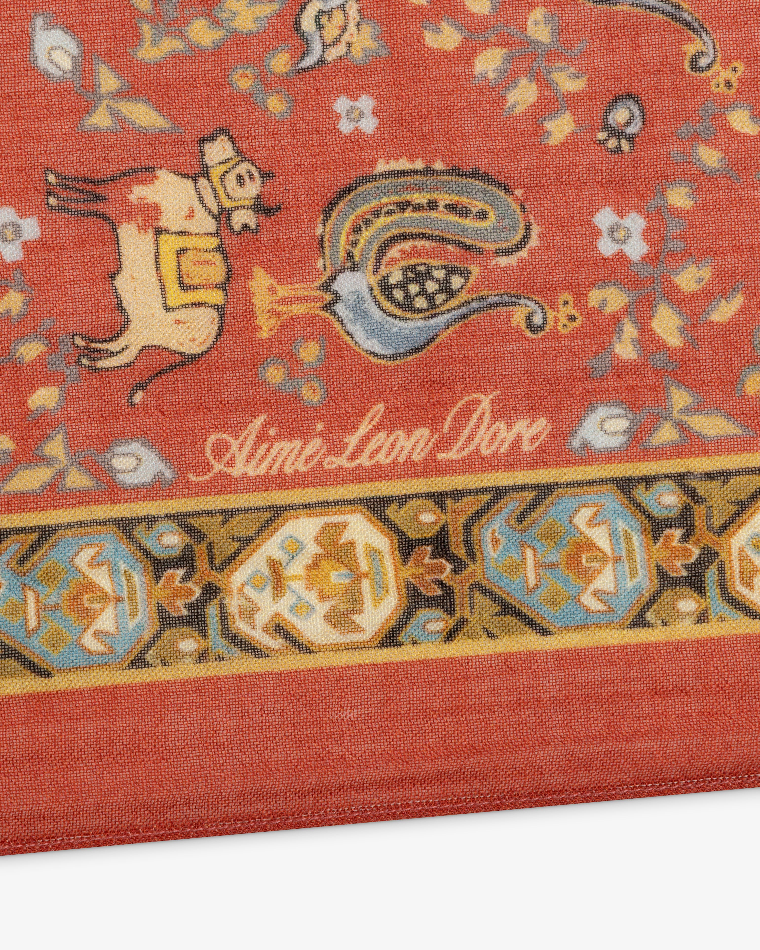 Archival Print Wool Silk Bandana with red pattern, Aimé Leon Dore script, animal motifs, and a decorative border.