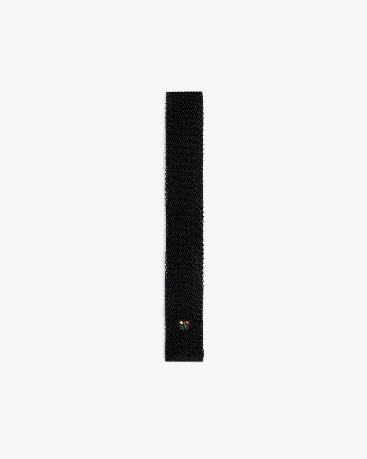 Crest Silk Knit Tie in black with small floral embroidery near the pointed tip.