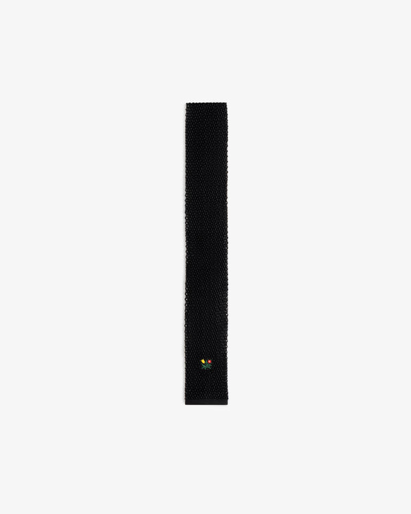 Crest Silk Knit Tie in black with small floral embroidery near the pointed tip.