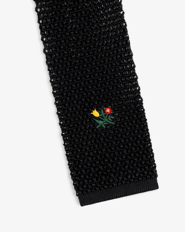 Crest Silk Knit Tie in black with a small embroidered floral motif.