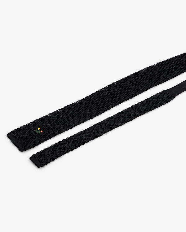Crest Silk Knit Tie in black, featuring small floral embroidery near the tip.