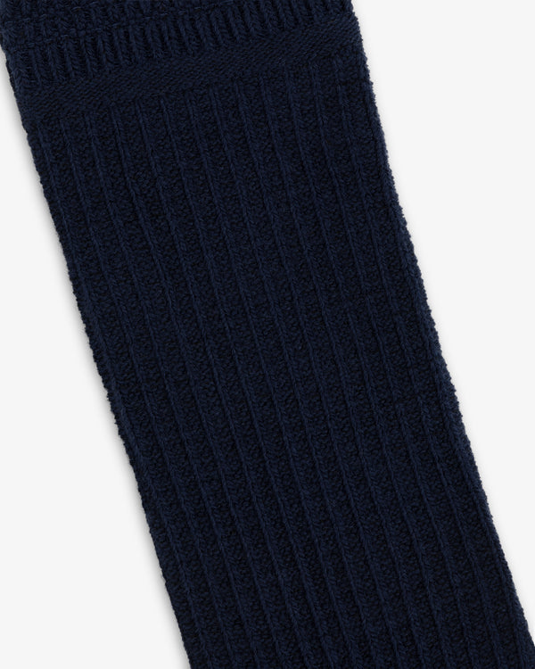 A dark blue Cotton Waffle Sock with a ribbed knit texture.