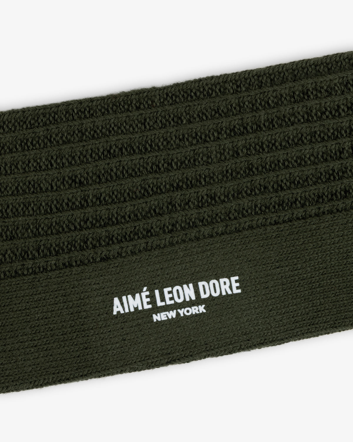 Olive green Cotton Waffle Sock cuff featuring a textured waffle-knit pattern and the brand name printed in white.