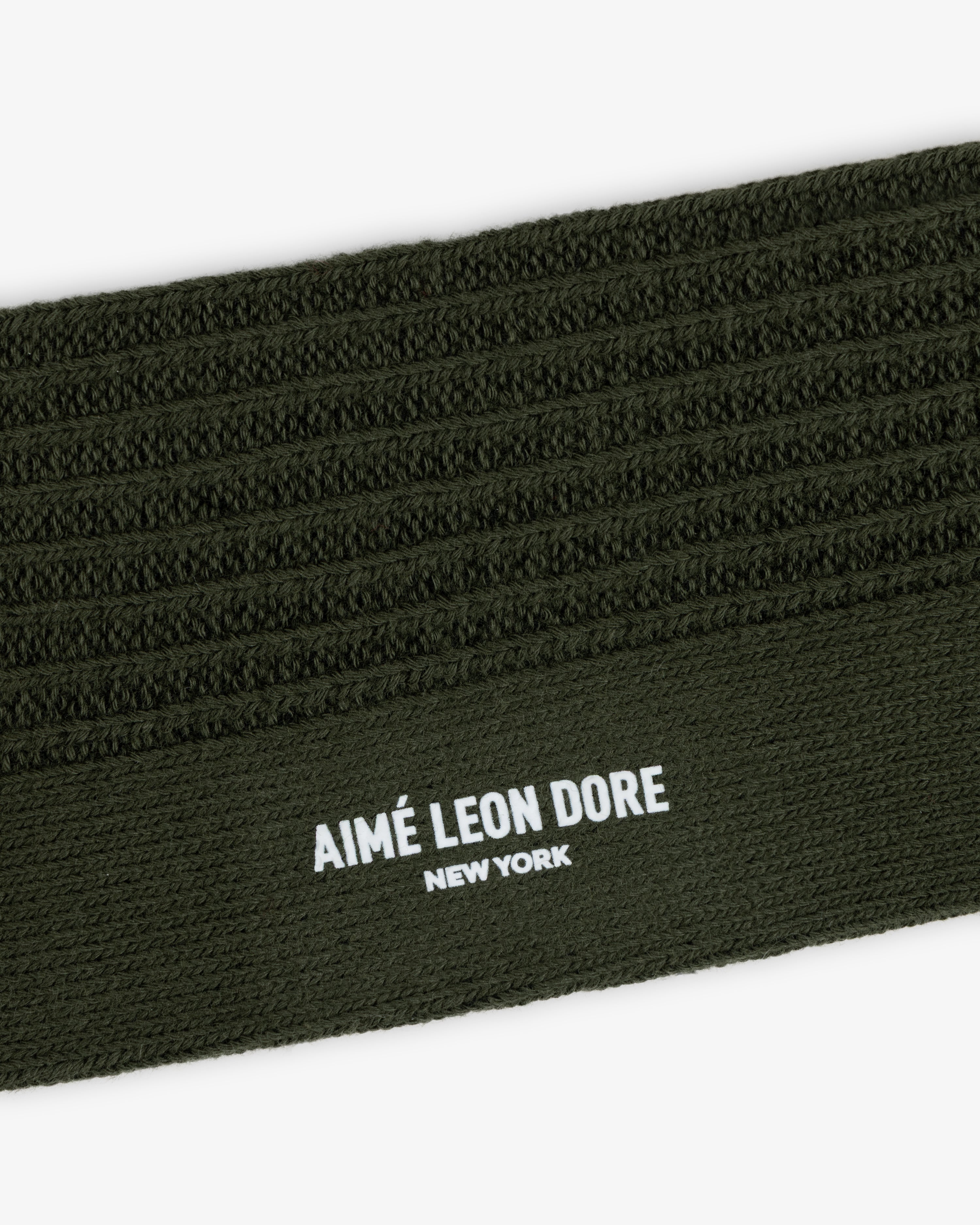 Olive green Cotton Waffle Sock cuff featuring a textured waffle-knit pattern and the brand name printed in white.
