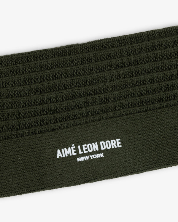 Olive green Cotton Waffle Sock cuff featuring a textured waffle-knit pattern and the brand name printed in white.