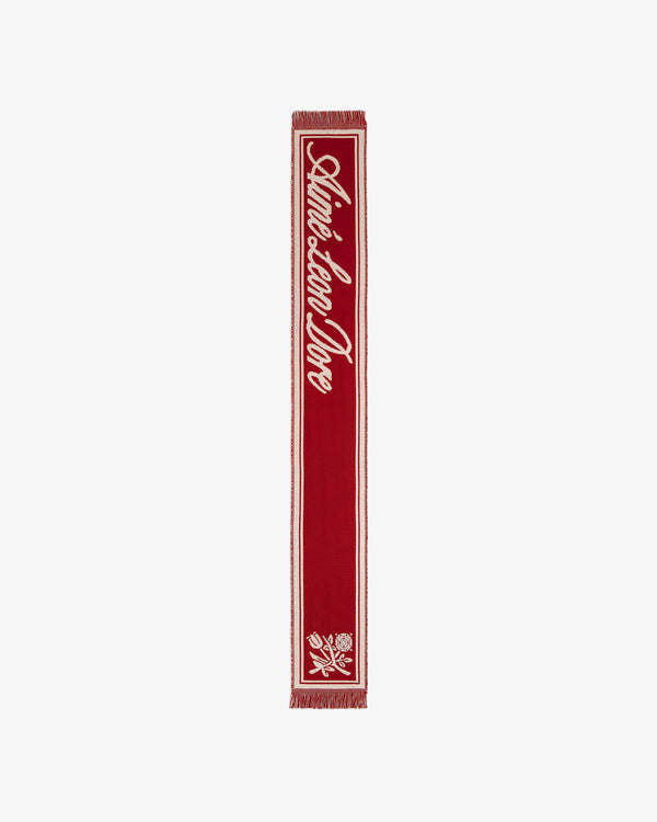 Red Wool Script Scarf featuring white script text and a floral graphic at the base.