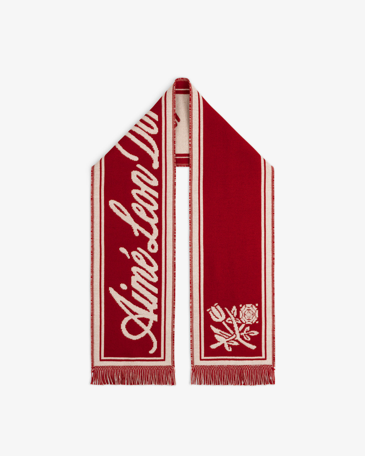 Wool Script Scarf in red with white cursive text, a white flower graphic, and fringed edges.