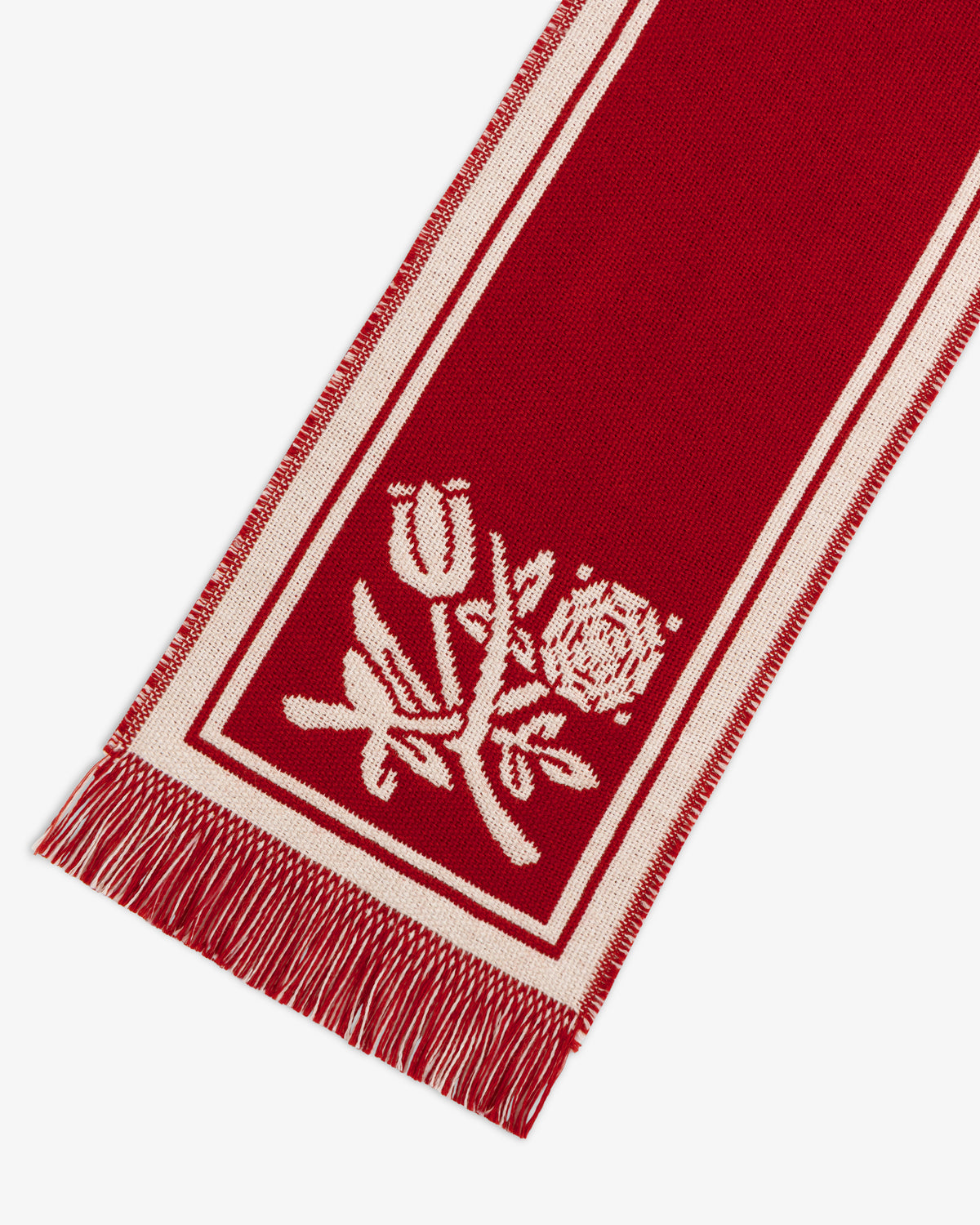 Wool Script Scarf in red with white borders, fringe ends, and a woven floral motif.