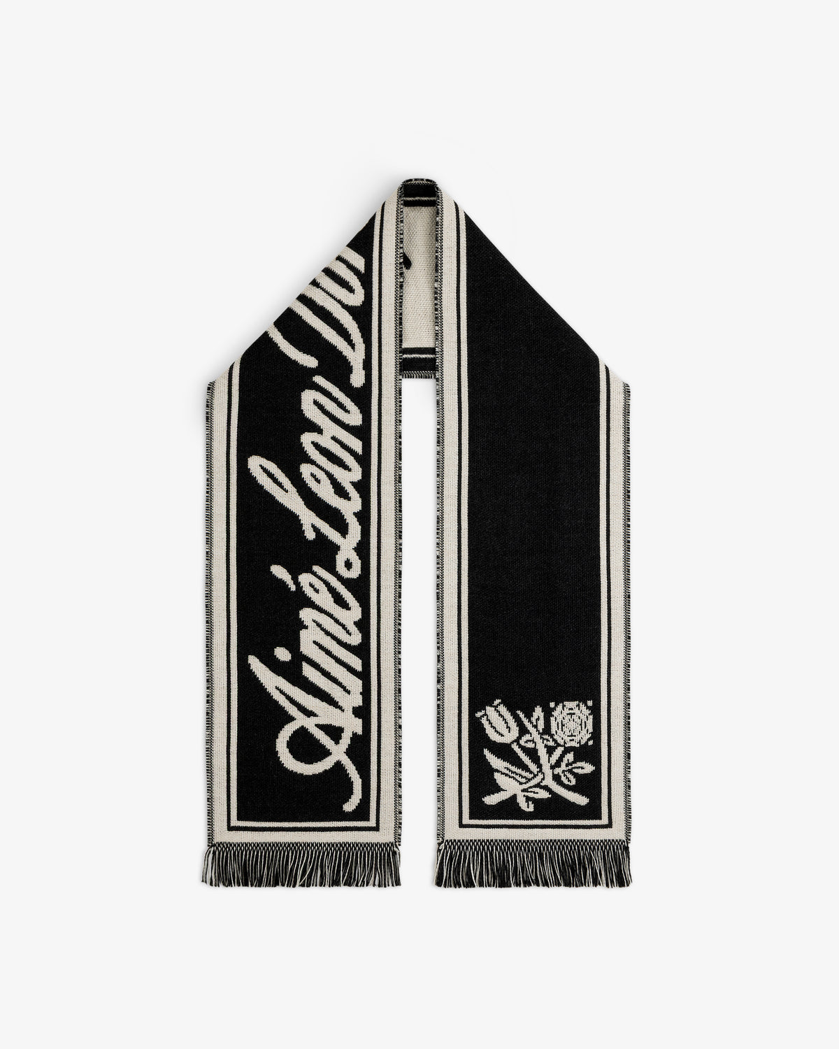 Wool Script Scarf in black and off-white with a script logo on one end, a floral graphic on the other, and fringe trim.
