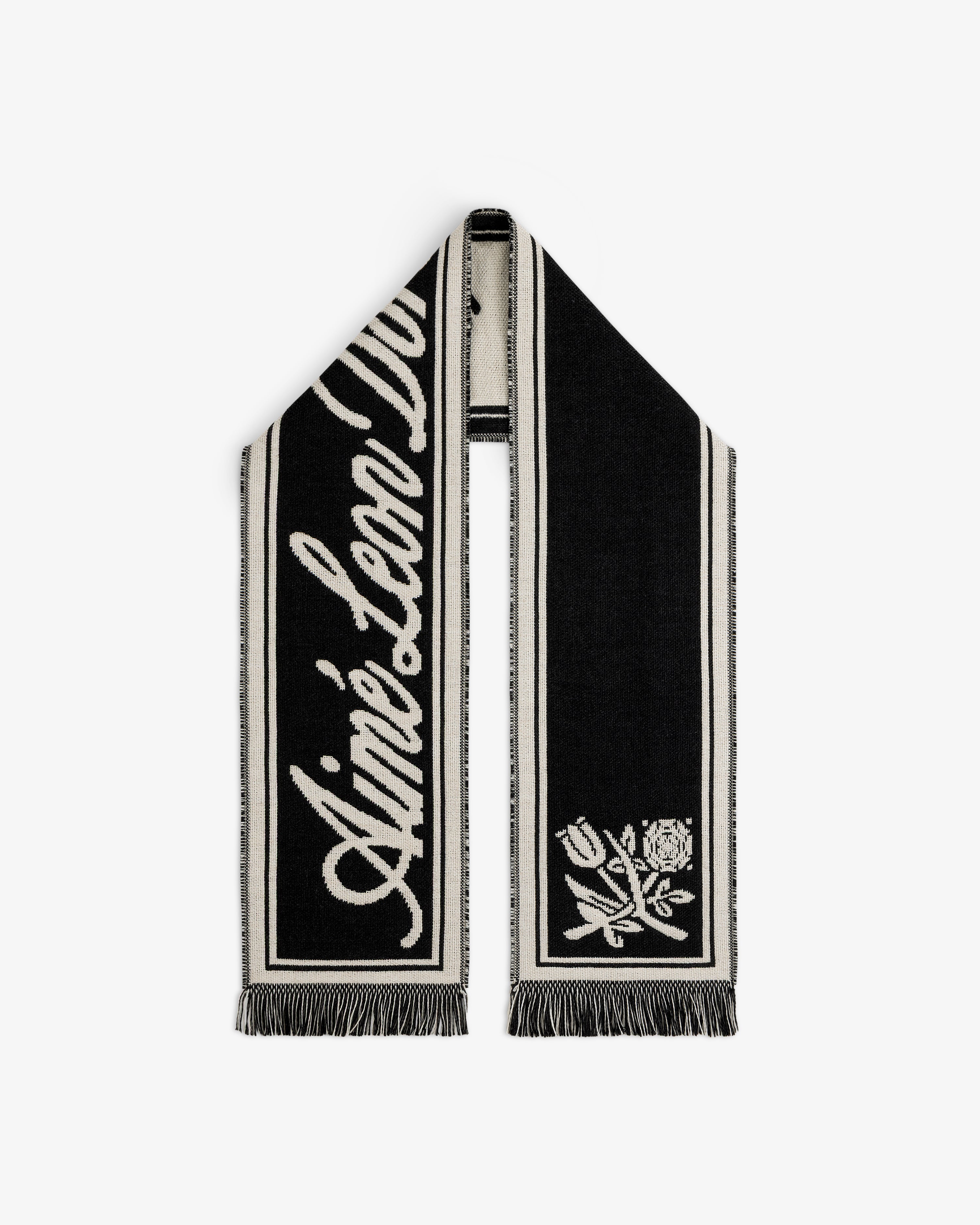 Wool Script Scarf in black and off-white with a script logo on one end, a floral graphic on the other, and fringe trim.