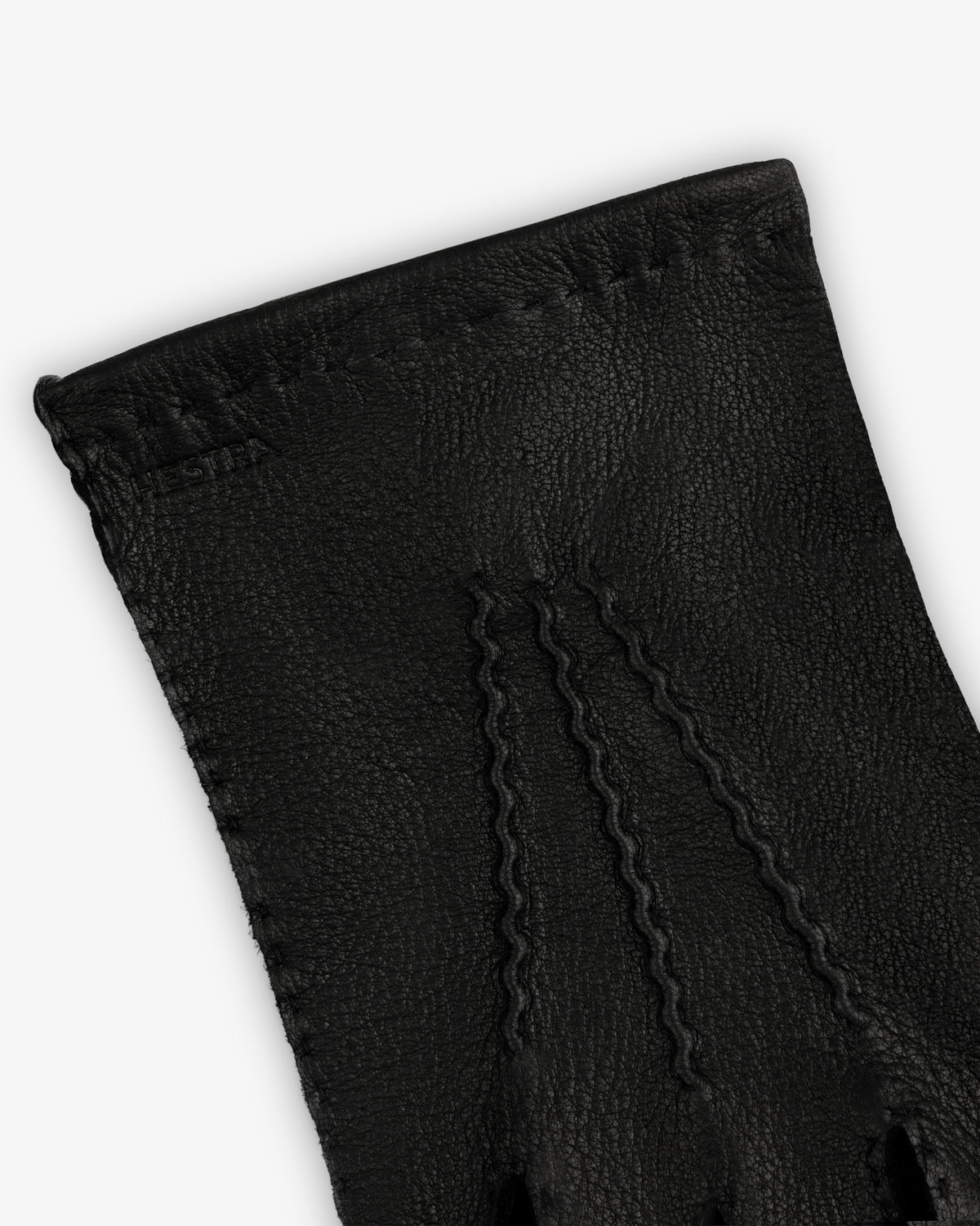 Close-up of a black leather Henry Glove with three rows of decorative stitching on the back.