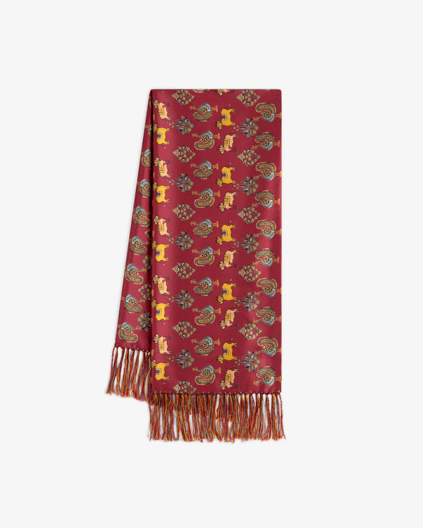 Archival Print Silk Fringe Scarf in red silk with a stylized animal and paisley pattern and fringed ends.