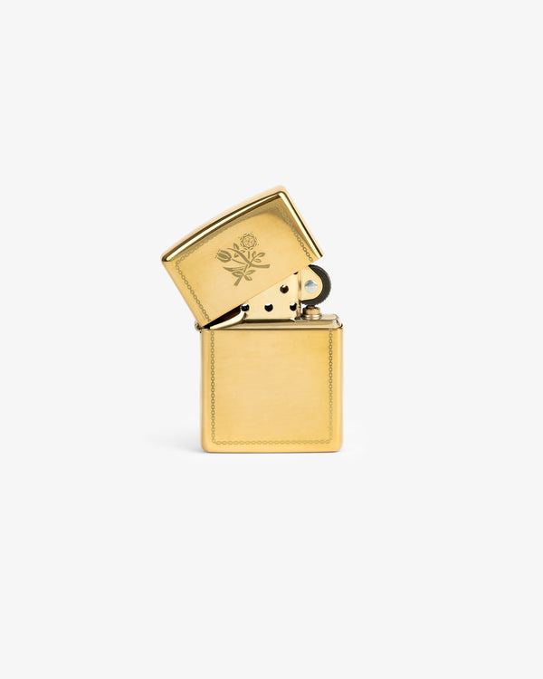 A Graphic Zippo Lighter with an open lid, engraved with florals, is shown against a white background.
