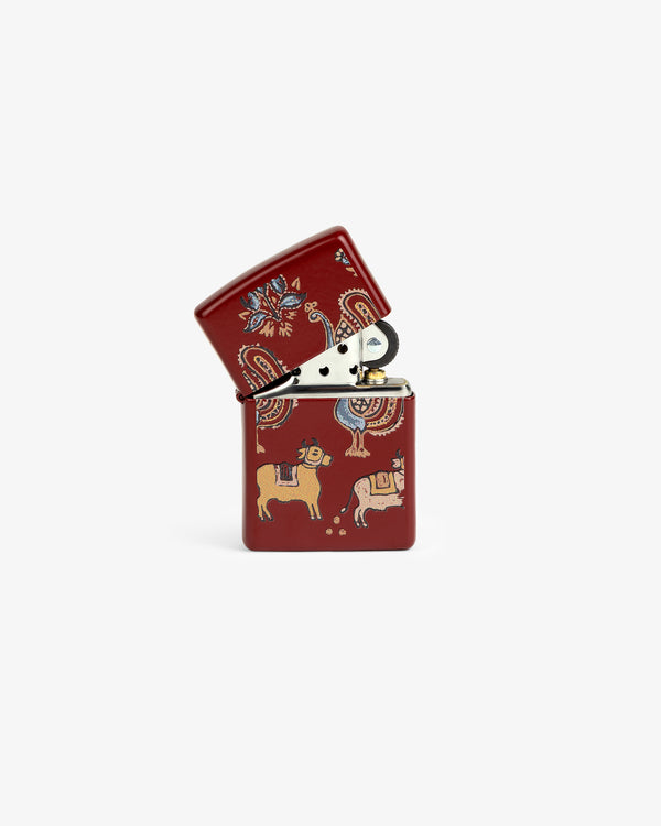 Graphic Zippo Lighter with folk art patterns and animals on white, shown open with the lid flipped back.