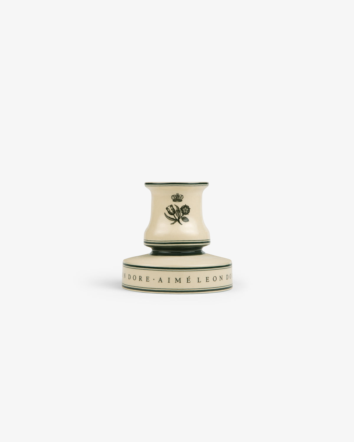 A cream porcelain match striker with a rose design and black text around the base on a white background.