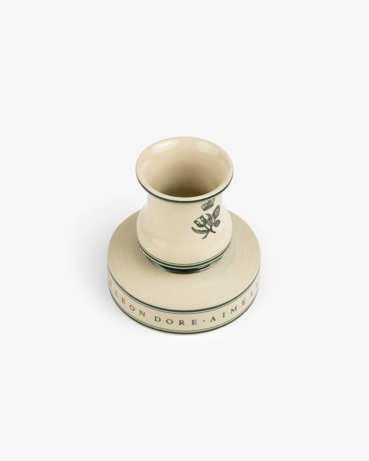 Porcelain Match Striker in cream with a green floral motif, set on a matching round base with inscription.