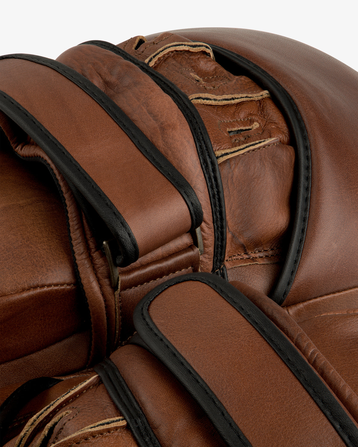 Close-up of brown Atlas Vintage Leather Boxing Pads with black trim and stitched strap details.
