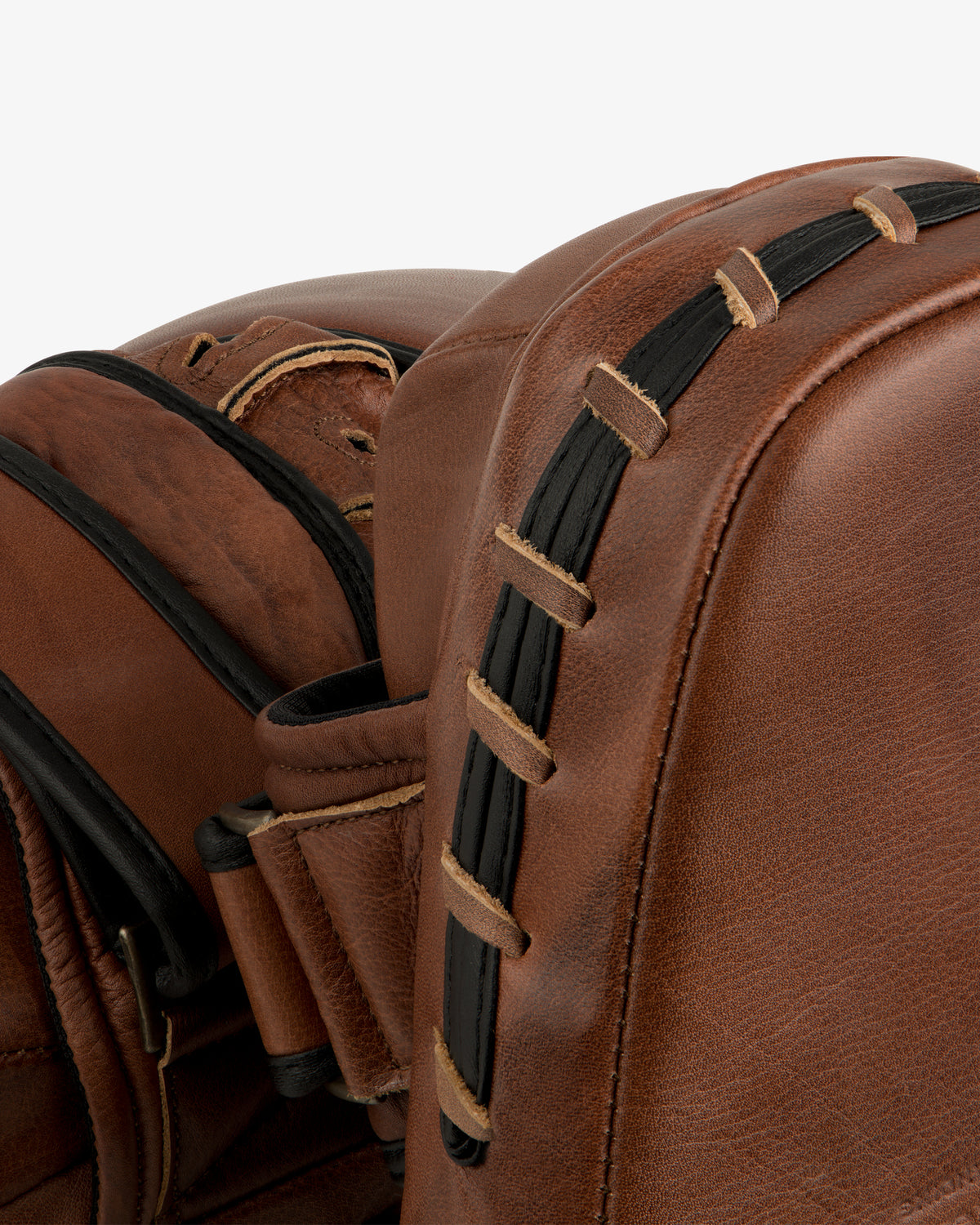 Two brown leather Atlas Vintage Leather Boxing Pads with black laced side details.
