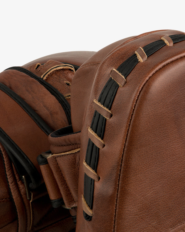 Two brown leather Atlas Vintage Leather Boxing Pads with black laced side details.