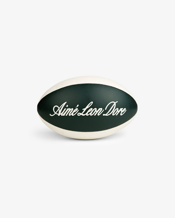 A green and white Script Rugby Ball with Aimé Leon Dore in cursive, shown on a white background.