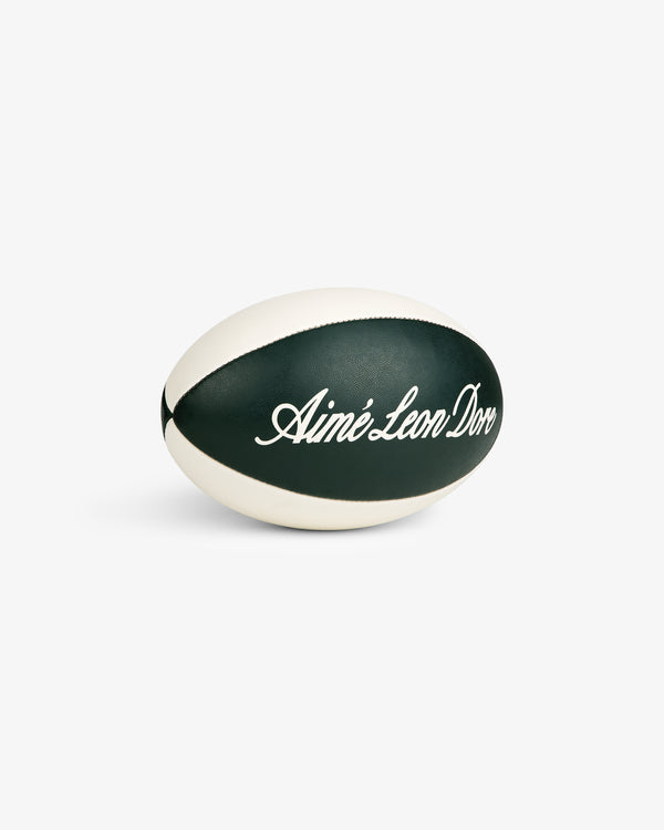 Script Rugby Ball in black and white with cursive Aimé Leon Dore text, displayed on a white background.