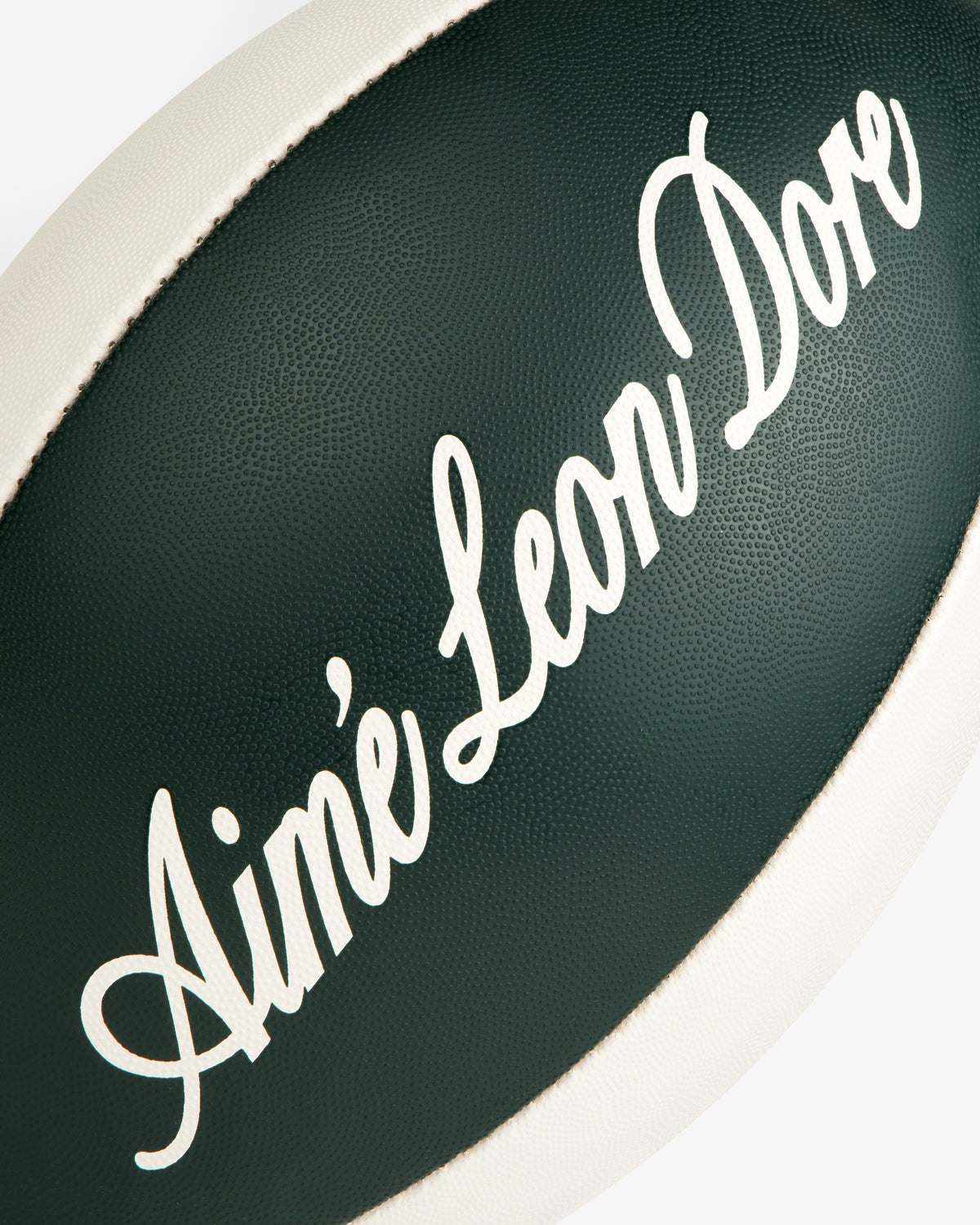 Script Rugby Ball: Dark green ball with Aimé Leon Dore in white script and white trim.