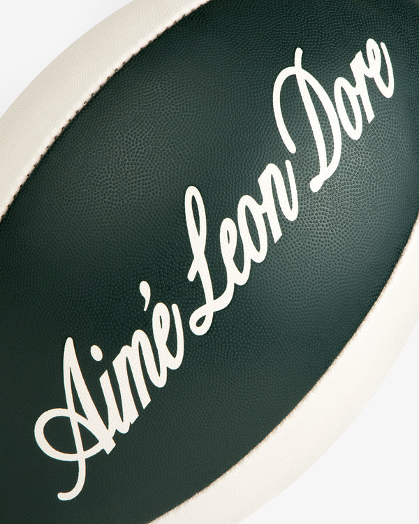 Script Rugby Ball: Dark green ball with Aimé Leon Dore in white script and white trim.