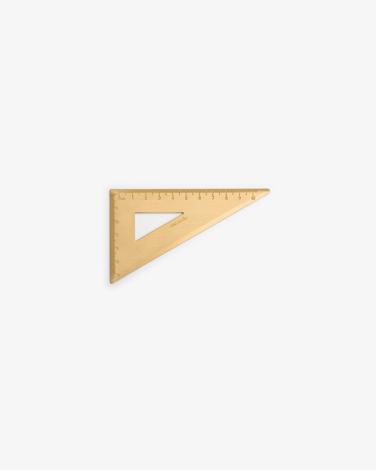 The Brass Measurement Kit features a triangular ruler with cut-out center and measurement markings on its edges.