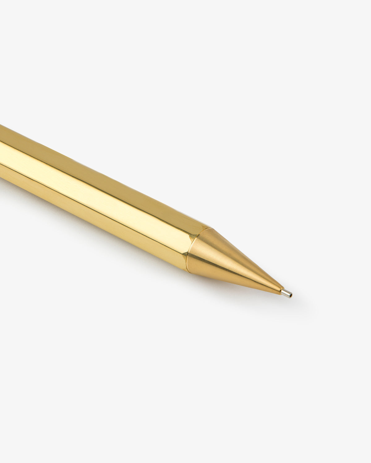 A close-up of the Kaweco Script Mechanical Pencil’s shiny gold tip against a plain white background.