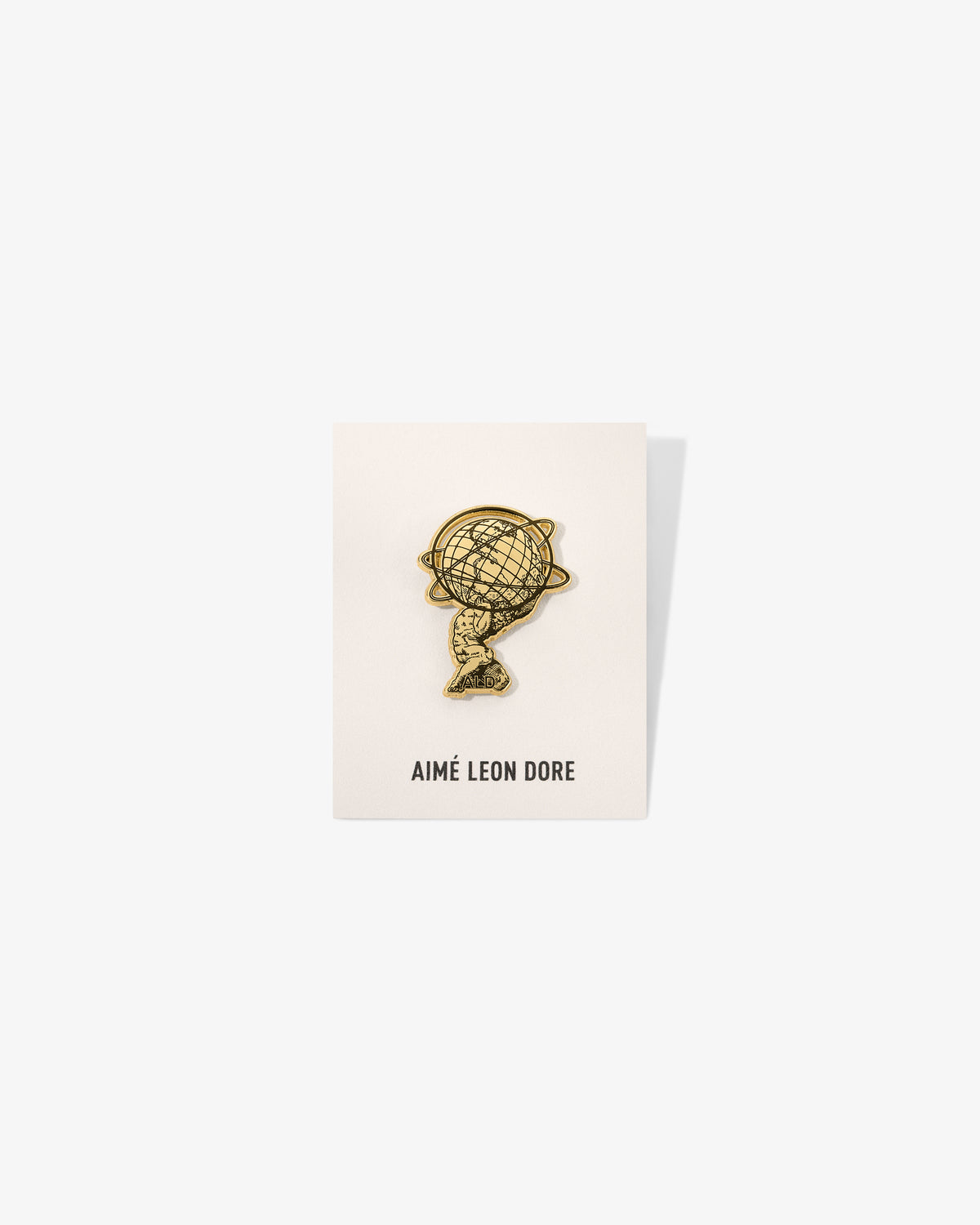 Graphic Pin displayed on a white AIMÉ LEON DORE card, photographed against a white background.