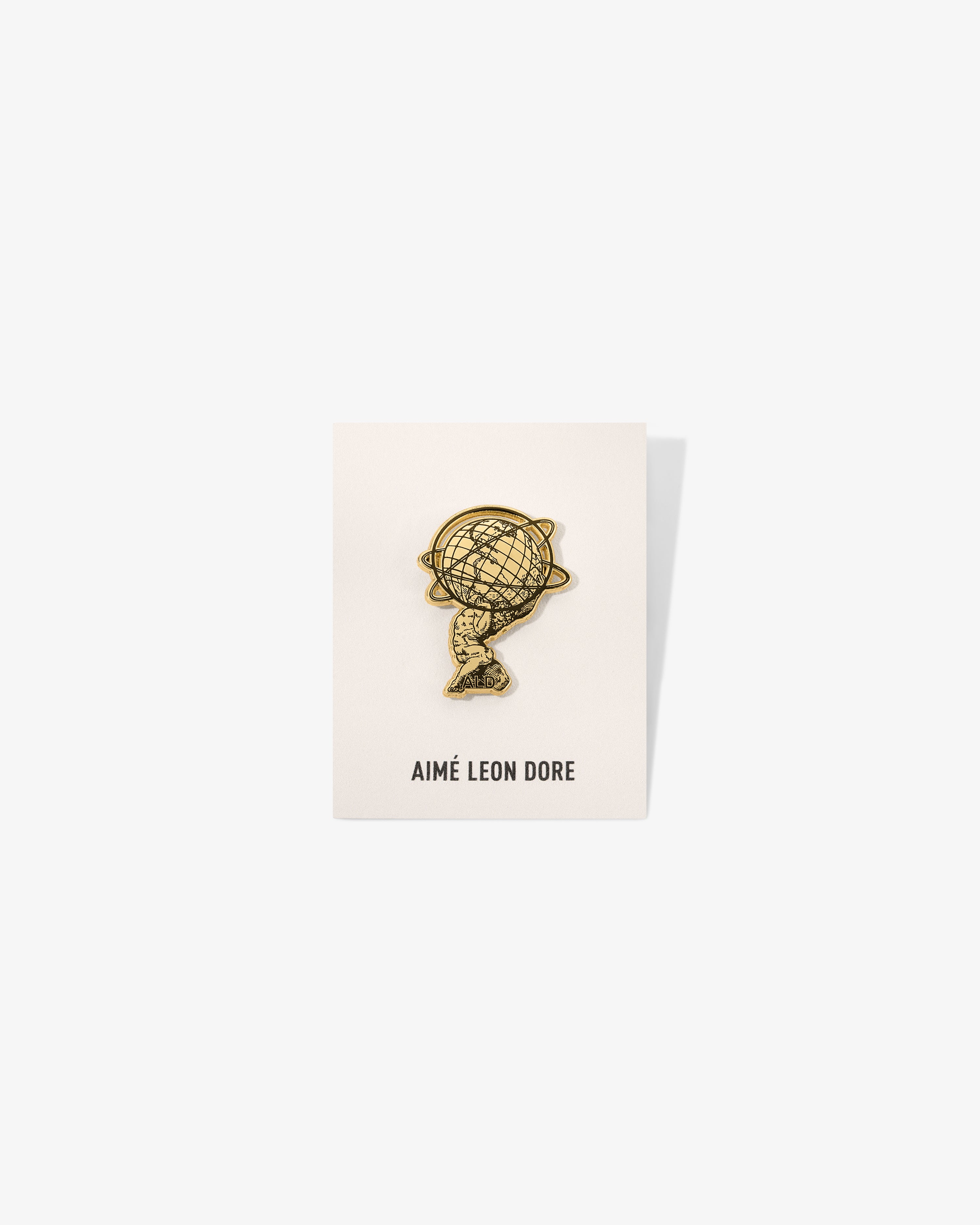 Graphic Pin displayed on a white AIMÉ LEON DORE card, photographed against a white background.