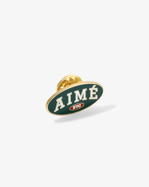 Graphic Pin with white ‘AIMÉ’ on green, gold border, and small NYC logo below.