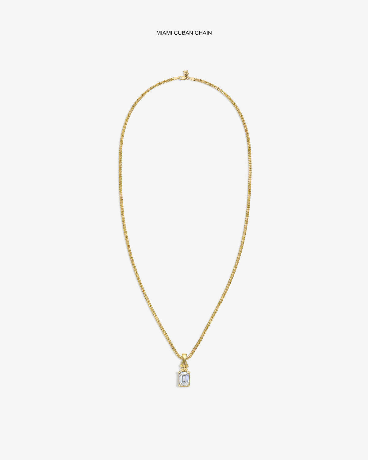 14Kt Gold Crest Gemstone Pendant Miami Cuban chain necklace on a plain white background.