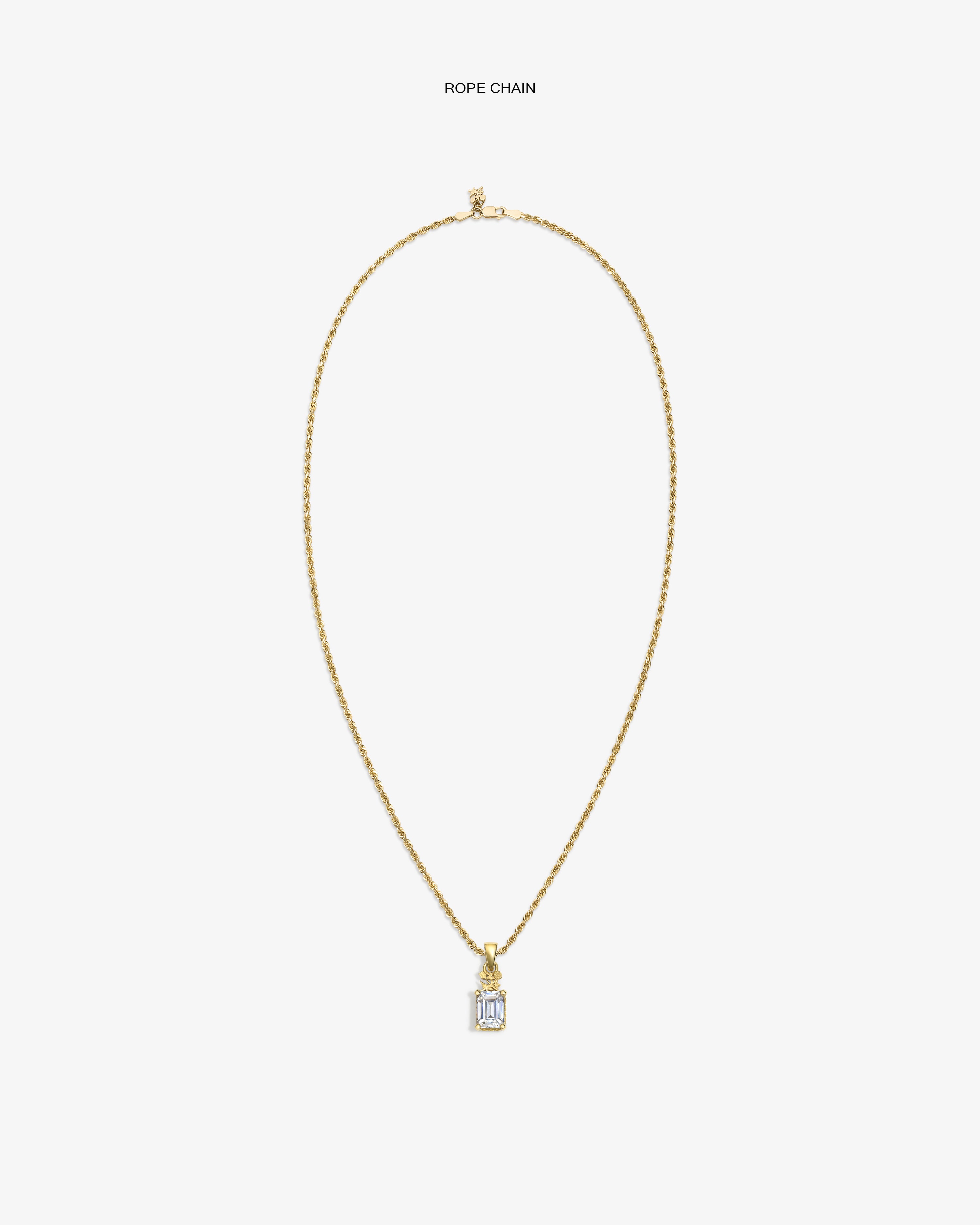 14Kt Gold Crest Gemstone Pendant on rope chain, rectangular with clear gem, shown against a white background.