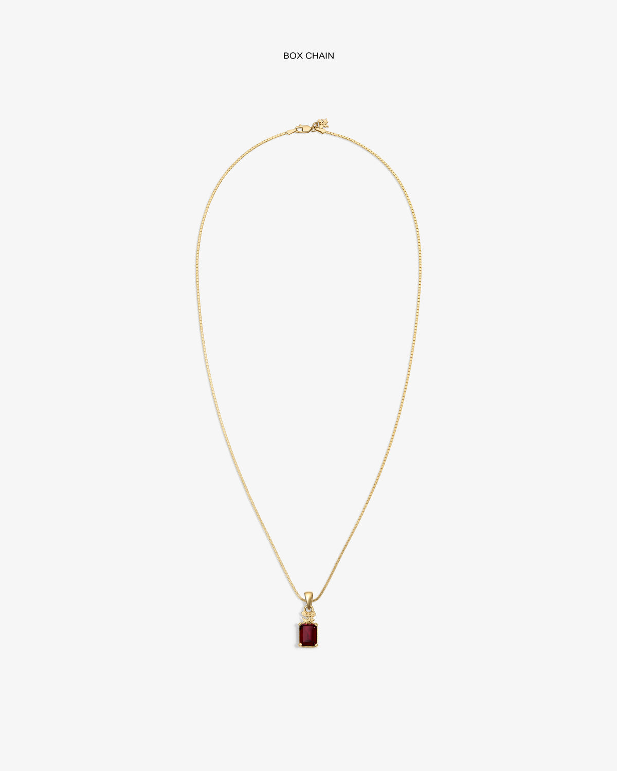 14Kt Gold Crest Gemstone Pendant with rectangular red stone on box chain, shown on white background.