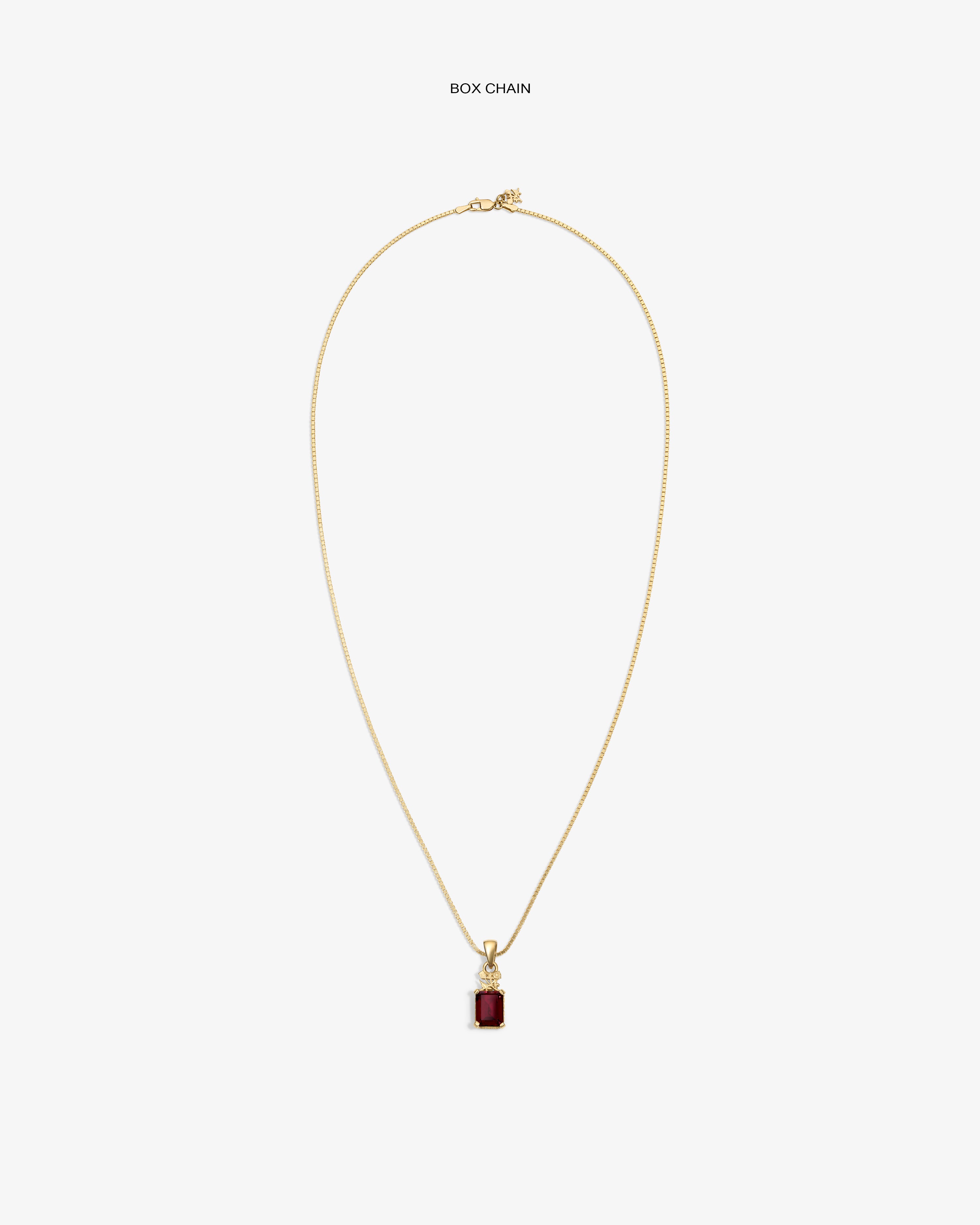 14Kt Gold Crest Gemstone Pendant with rectangular red stone on box chain, shown on white background.