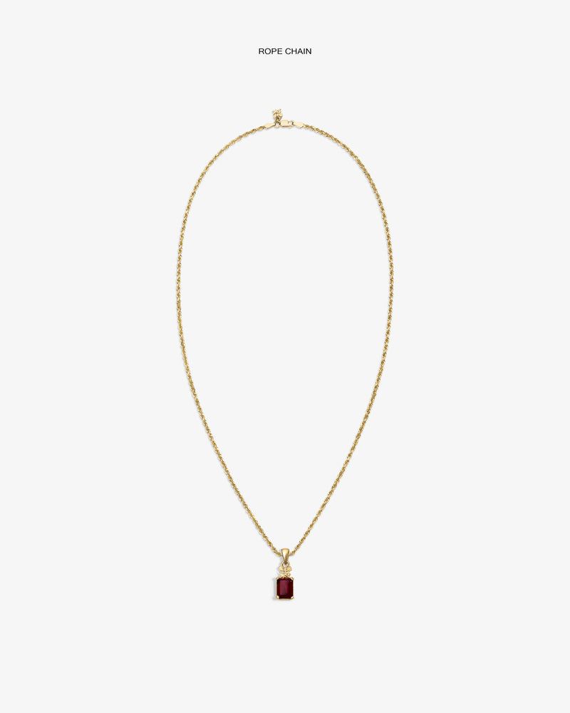 14Kt Gold Crest Gemstone Pendant with a red stone, shown on a plain white background.