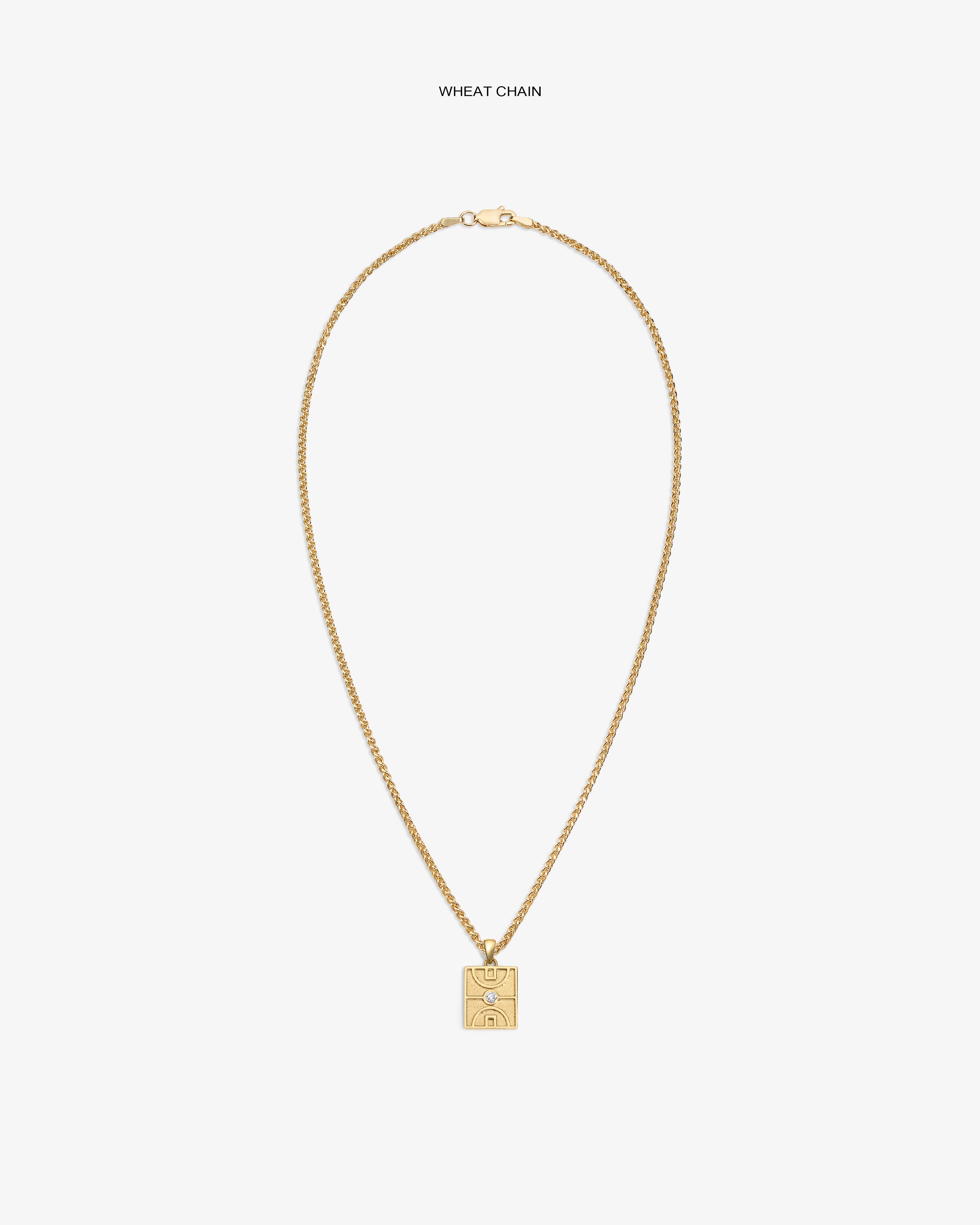 14Kt Gold Diamond Court Pendant on a wheat chain, featuring an engraved abstract face, set against a white background.