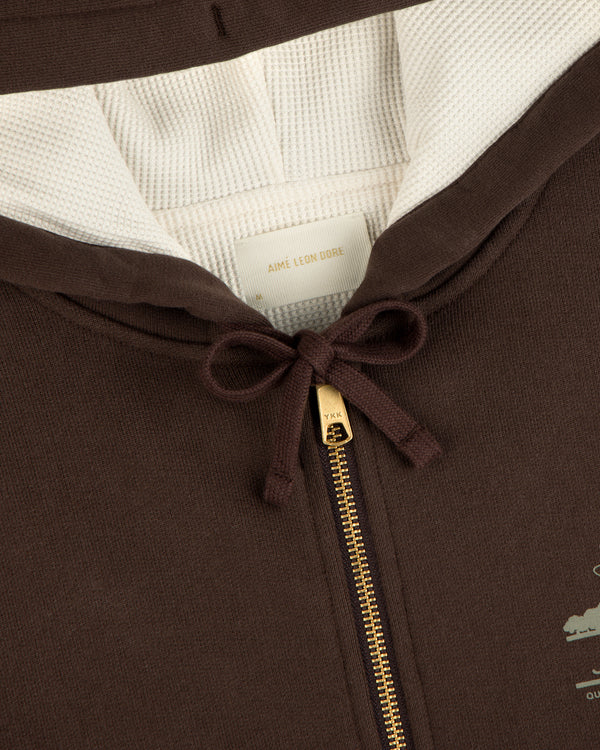 Close-up of the Unisphere Waffle Lined Full-Zip Hoodie with a gold zipper, cream lining, and neck bow.