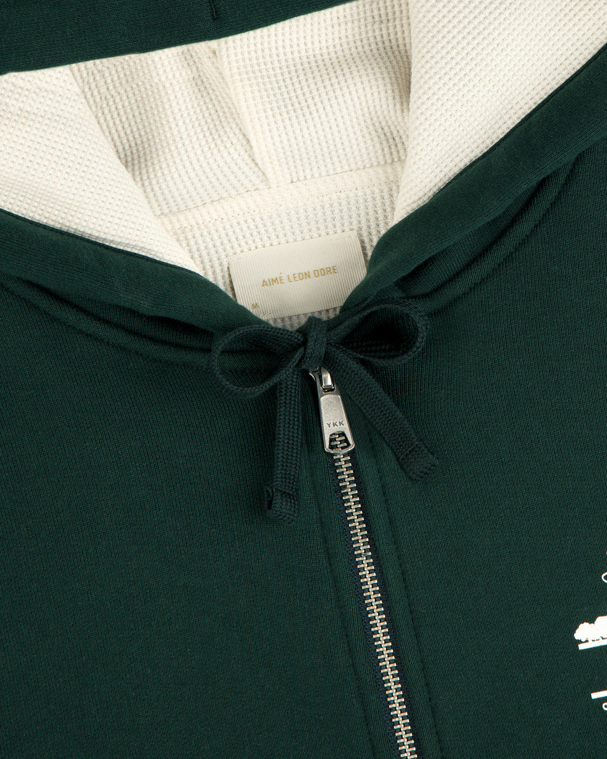 Unisphere Waffle Lined Full-Zip Hoodie in dark green with metal zipper, drawstring, and inside Aimé Leon Dore label.