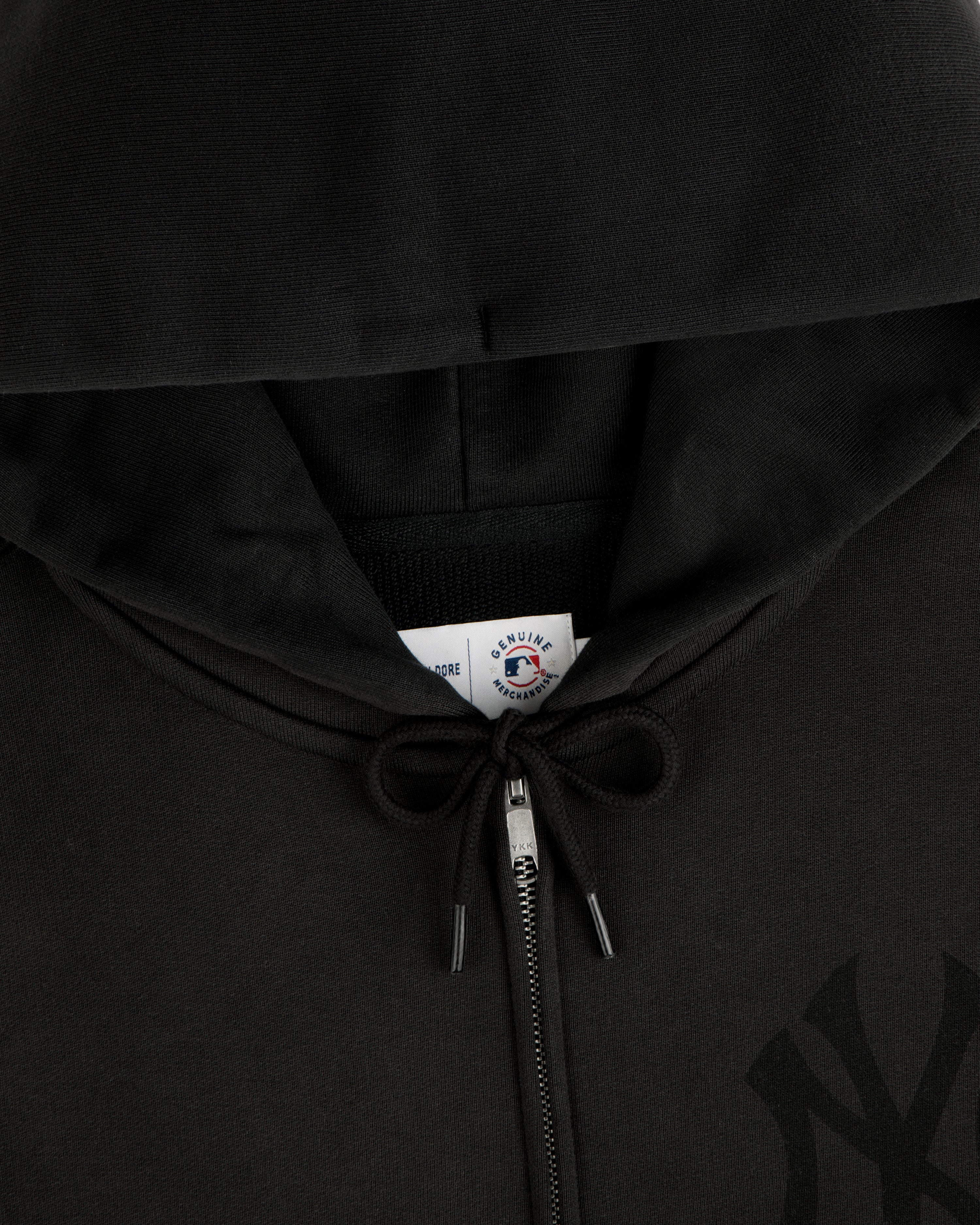 Yankees Washed Full-Zip Hoodie with drawstrings tied in a bow and visible collar tag.