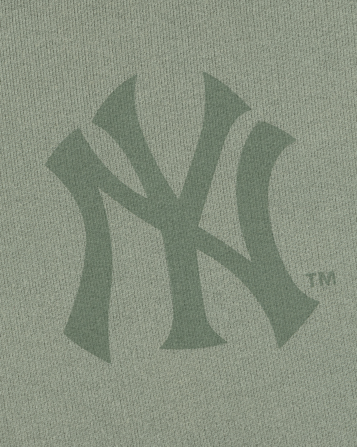 Close-up of the Yankees Washed Full-Zip Hoodie featuring a green New York Yankees logo on the fabric.