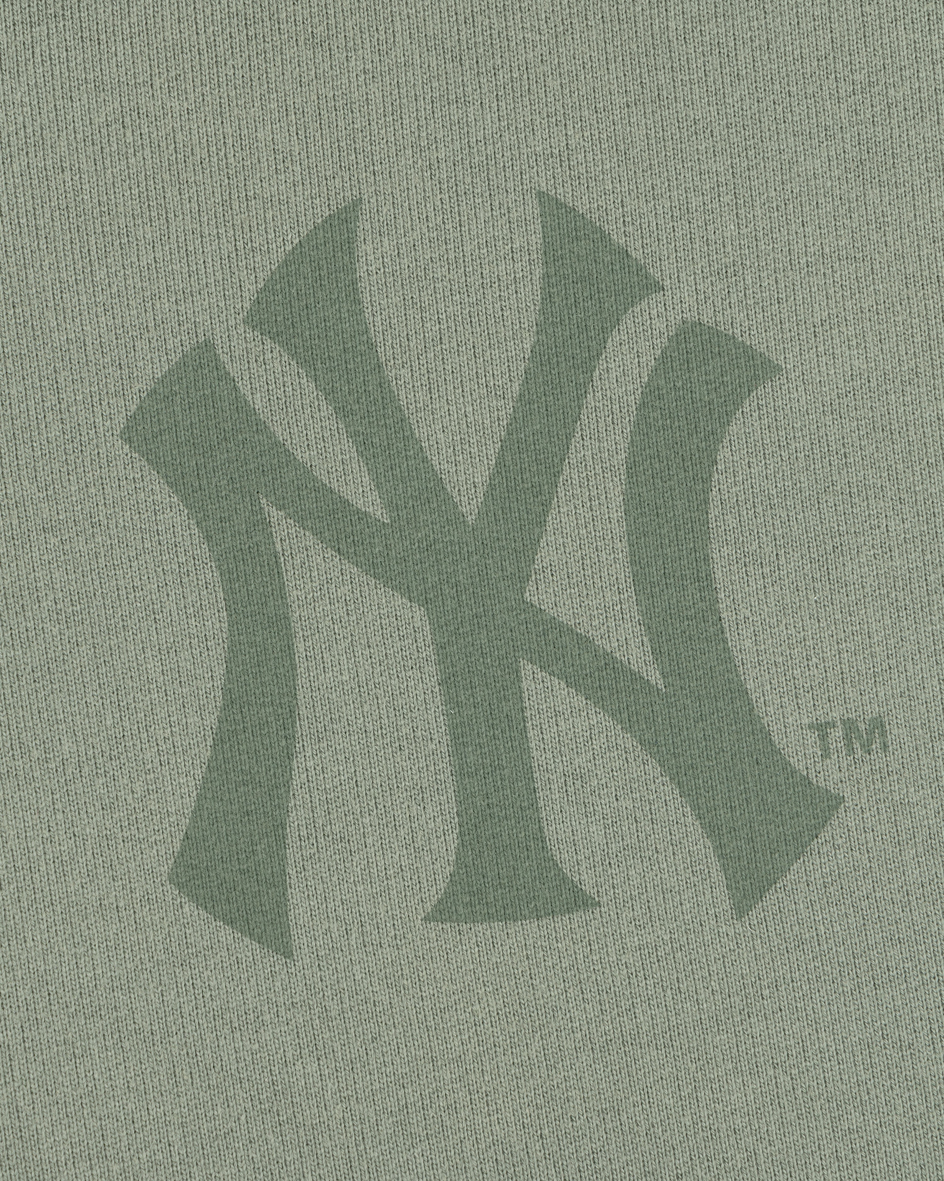 Close-up of the Yankees Washed Full-Zip Hoodie featuring a green New York Yankees logo on the fabric.