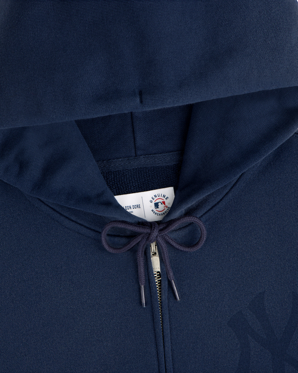 Yankees Washed Full-Zip Hoodie in navy blue with drawstrings and a visible collar tag under the hood.