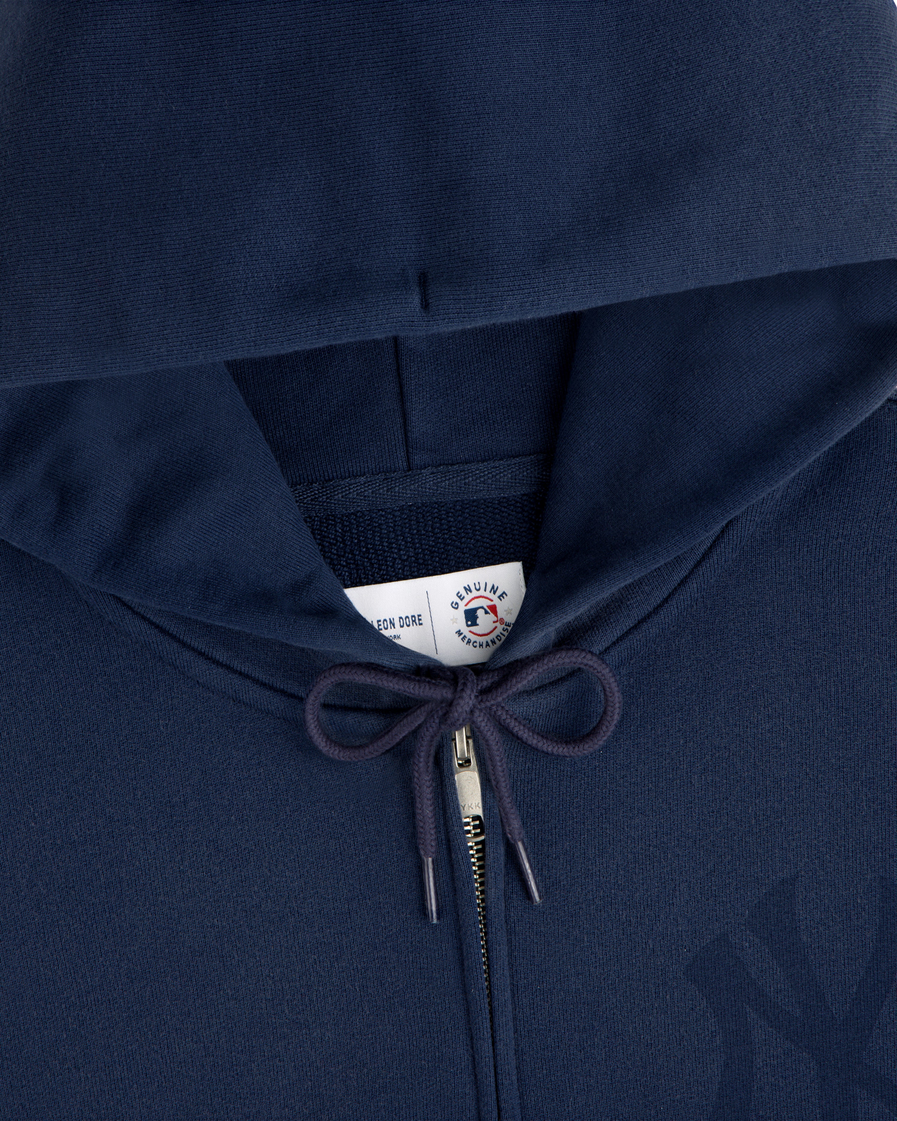 Yankees Washed Full-Zip Hoodie in navy blue with drawstrings and a visible collar tag under the hood.