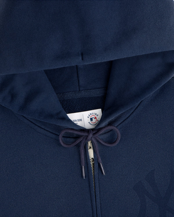 Yankees Washed Full-Zip Hoodie in navy blue with drawstrings and a visible collar tag under the hood.